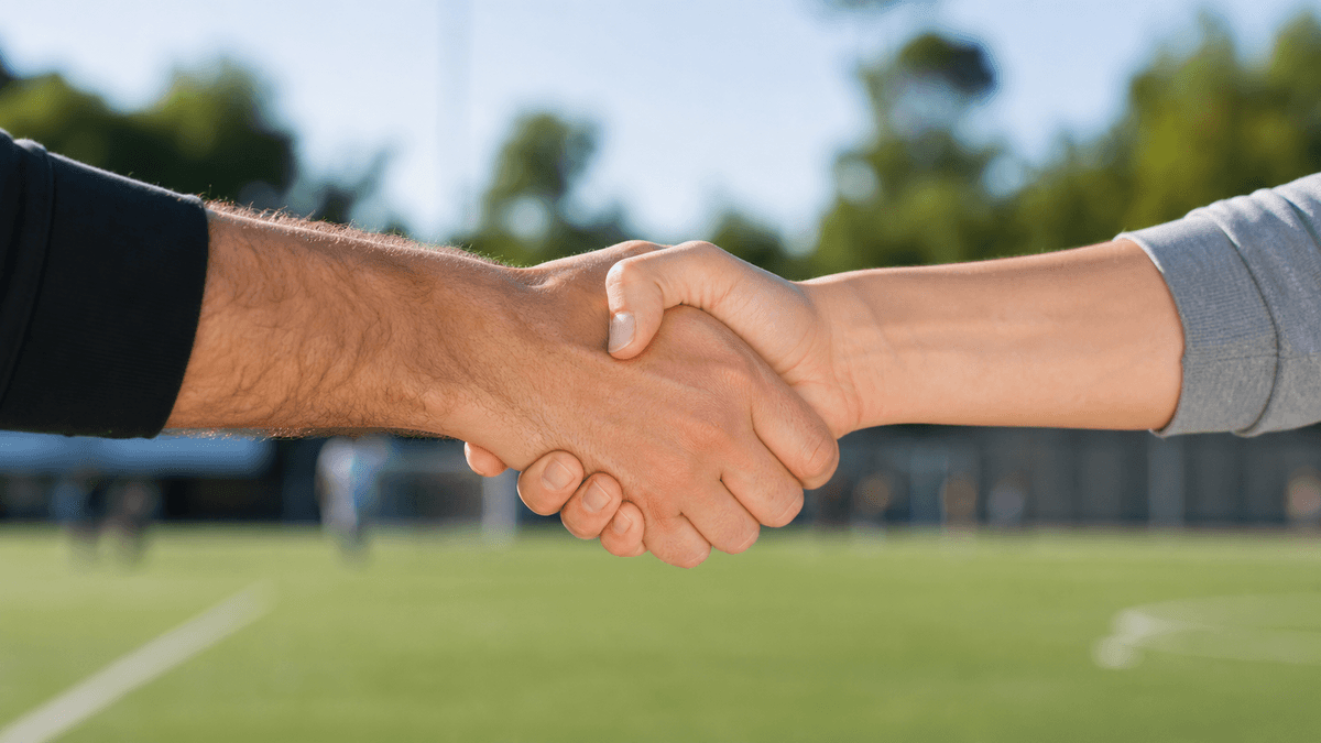 Stretta di mano tra un uomo e una donna al centro sportivo